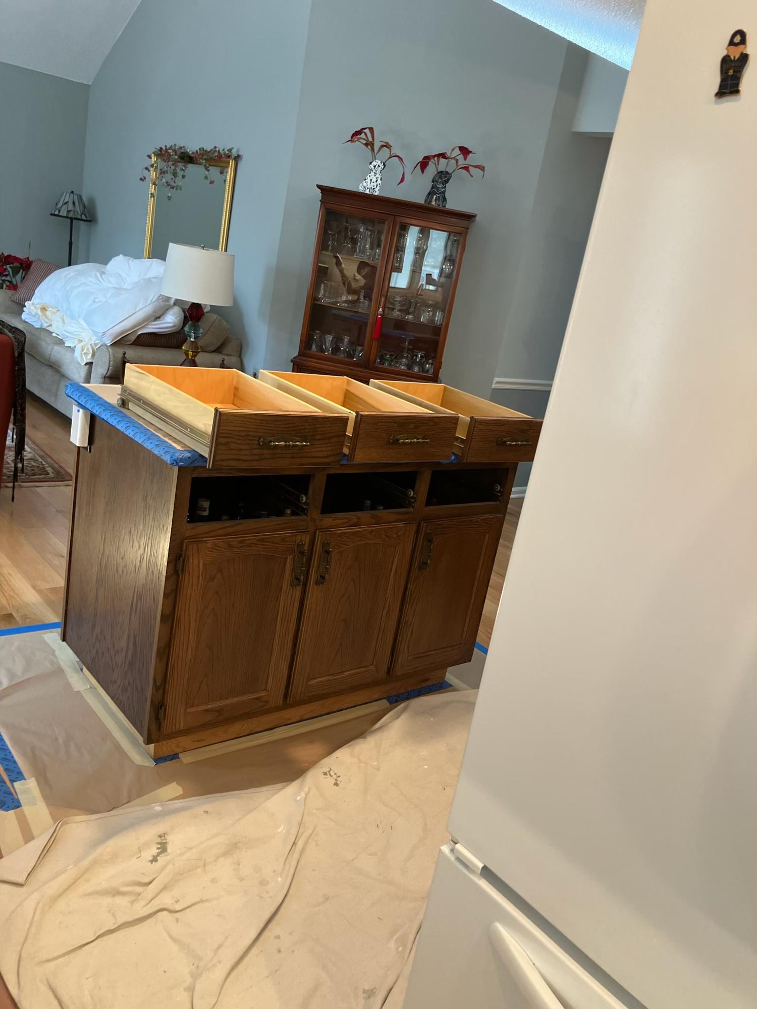 Kitchen island with drawers removed and boxes prepped for paint