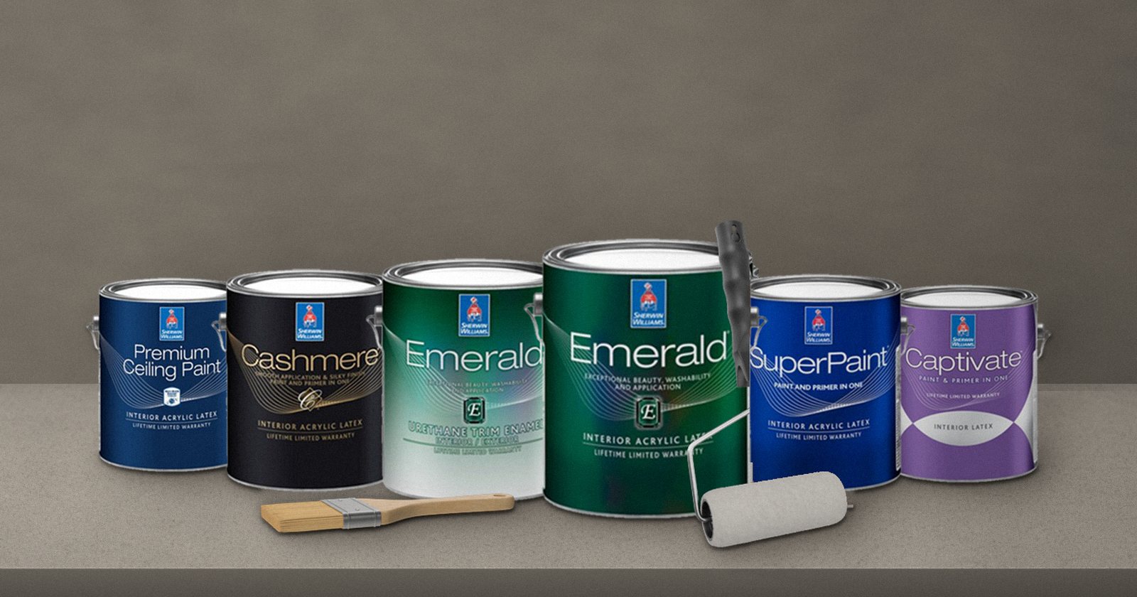 Sherwin-Williams paint cans including Emerald, Cashmere, SuperPaint and Captivate on a stone countertop